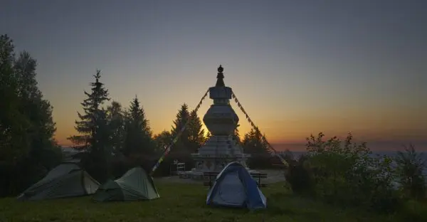 Picture of the Kalachakra Stupa on the beginning of the day with stunning view including 3 tents behind the Stupa.