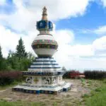 Kalachakra-Stupa new painted picture with the open valley behind with inspiring clear clouds and blue sky.