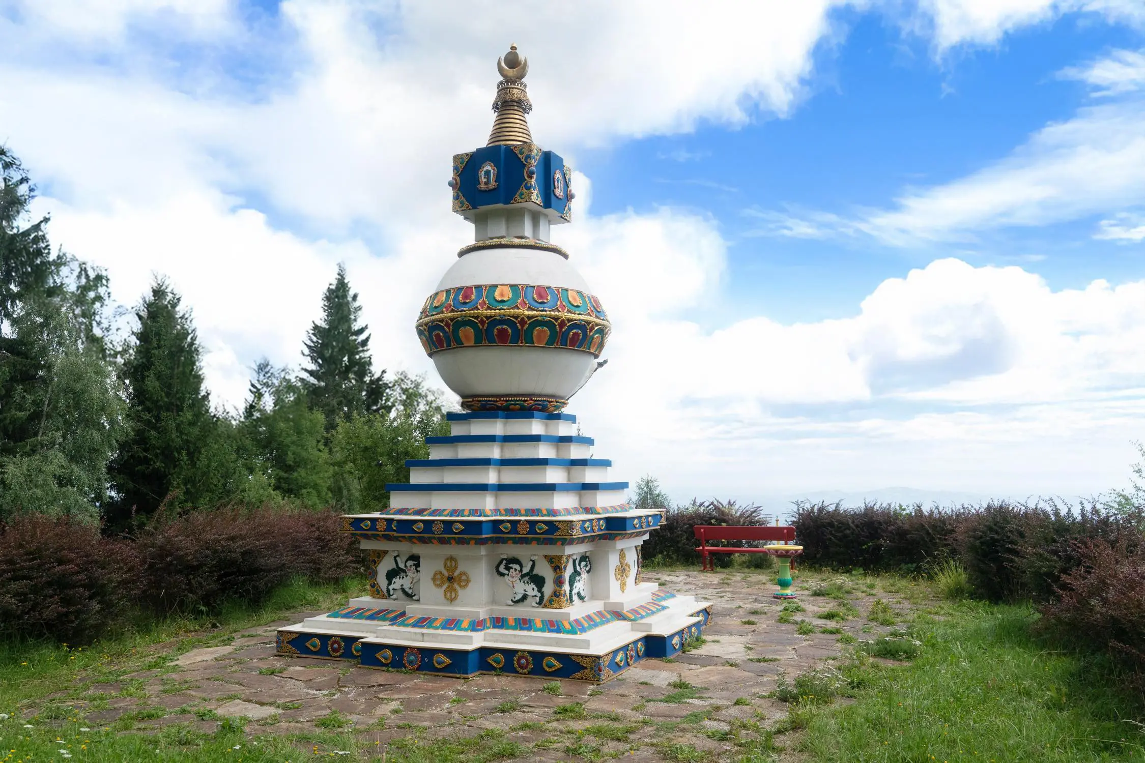 Kalachakra-Stupa new painted picture with the open valley behind with inspiring clear clouds and blue sky.